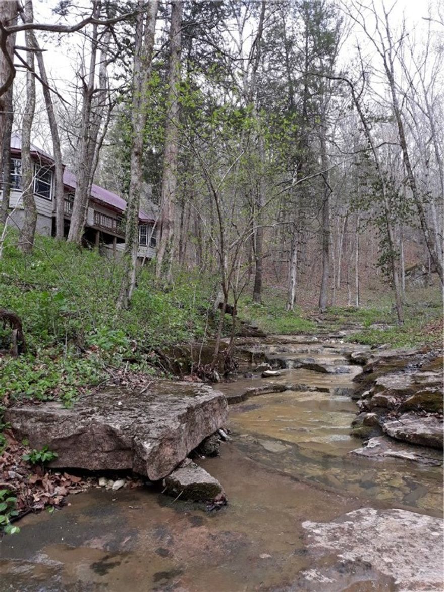Very peaceful & private setting in the woods with this 2056 Sq Ft, 3BR 2BATH house with 5 ac located near Jasper in beautiful Newton County, AR.  Features of the house include wood & tile flooring, cathedral ceiling, open area living room/kitchen, master bedroom with bay windows, deck, wood burning stove for heating & cooking (in addition to electric central HVAC), new hot water heater, new Morton water softener, new entire house pex plumbing, new "3 stage iSpring water filter", new low flush toilets & new pump for the drilled well. Features of the property include 3 outbuilding (20x40x10 garage/carport/barn, 20x30 metal storage bldg, wood bldg for firewood storage), seasonal waterfall, lg trees, rock outcrops & privacy entrance gate. Located near the historic Diamond Cave & Henson Creek. Located just 5 mi from Jasper with only 0.1 mile of gravel rd.  Perfect location for ATV & horseback riding. Near the Ozark National Forest & within the Buffalo National River Region of the Ozark Mountains. Abundance of wildlife.