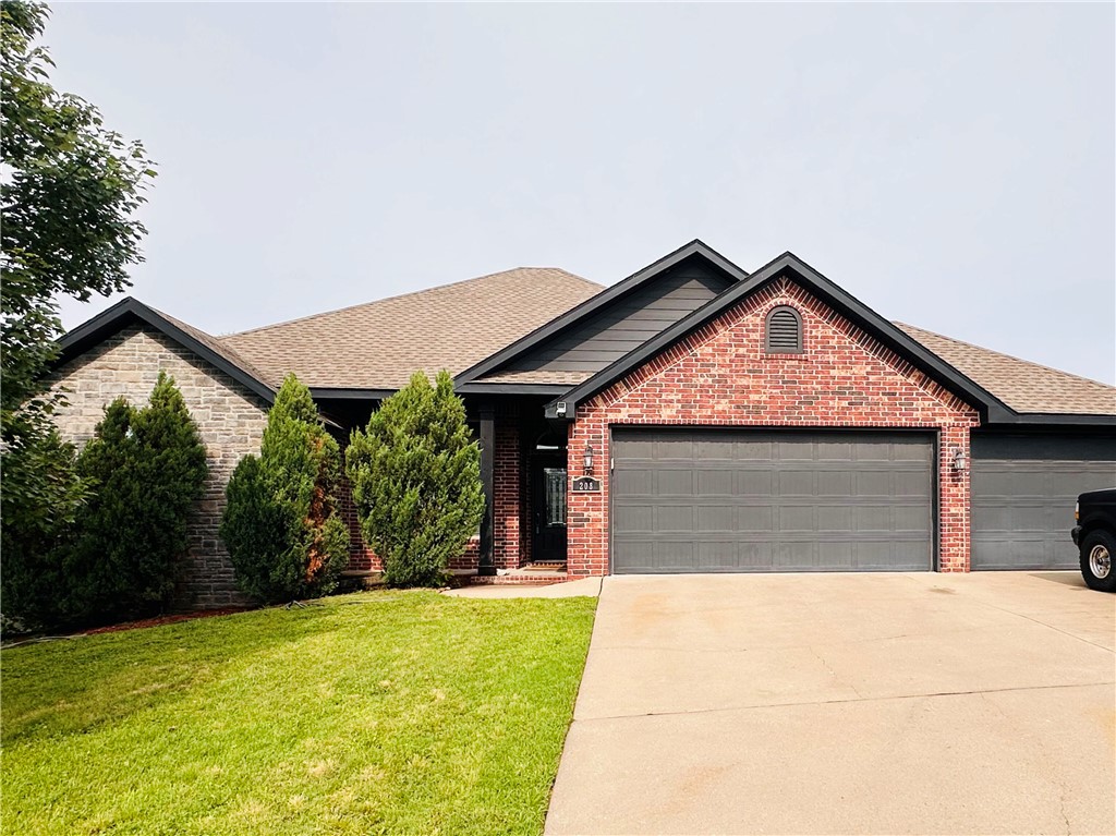 Ranch-style house featuring driveway, an attached