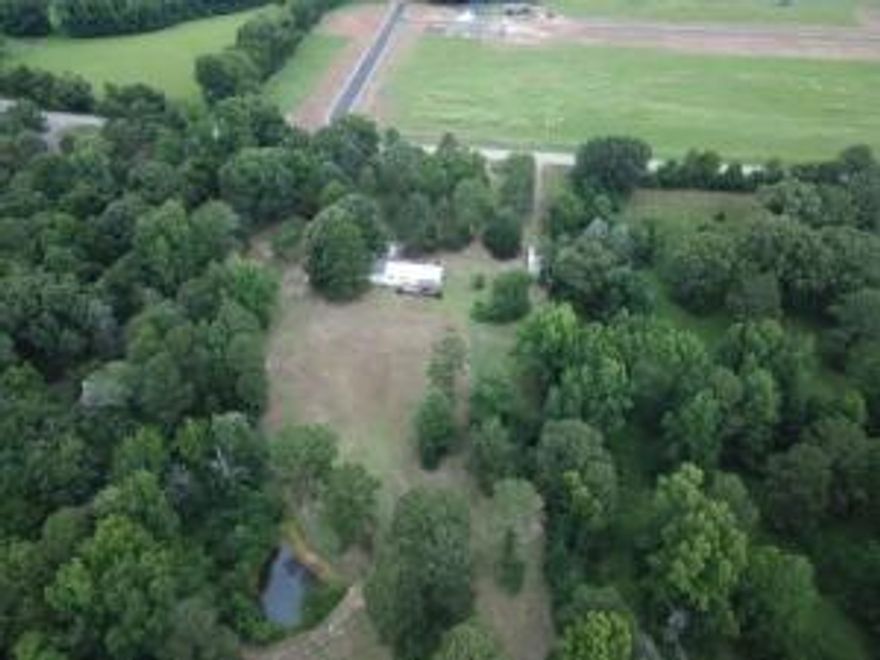 Looking for that property just on the outskirts of town with the country feel, but close to all the conveniences of town. Sit out on the covered back deck and watch the deer, owls and other wildlife while enjoying that morning cup of coffee! Enjoy the Pear tree and wild strawberries, blackberries and muscadines.This home on Nebo Road is sitting on 3.43 Acres with a pond. This 3 Bedroom/ 2 Bath isclose to Mount Nebo State Park and all the walking/biking trails. Book your showing today!!!