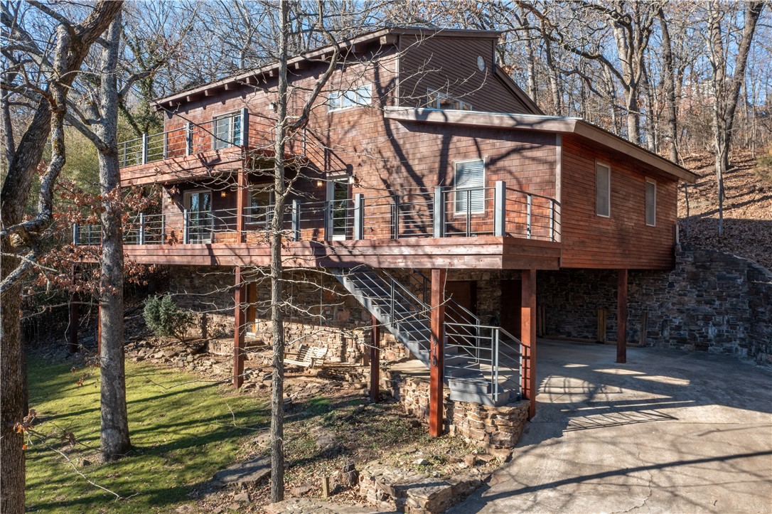 Seller is offering $5,000.00 buyer credit toward closing cost and pre-paids, with acceptable offer. Step inside and be captivated by the spaciousness of this truly remarkable residence that is located on top of Mt. Sequoyah. With 4 bedrooms and 3 bathrooms, there is ample room for your growing family or visiting guests. Spanning across 2,950 square feet, this home offers a perfect blend of comfort and style. Enjoy lazy afternoons on the patio, savoring the fresh mountain air and taking in the beauty of the surroundings. The first level of the house is the heated and cooled garage and a very spacious workshop. The main level of the house consists of the living room, dining room, kitchen, three bedrooms and two bathrooms. The top level has the master bedroom, bathroom and two flex rooms. The house sits on 3 lots. Embrace the unique charm and character of this home, and start creating memories that will last a lifetime.