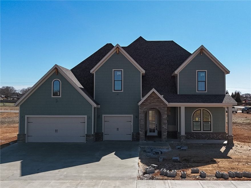 Welcome to County Line Square, a new Springdale community near Shaw Family Park with a pool and pavilion for residents. The entry opens to a bedroom and full bathroom on the right, then continues through an arched opening into the main living area. A fireplace anchors the space, while 4 large windows overlook the covered back patio and engineered hardwood floors extend throughout the first floor. The kitchen features include a large island, 3CM granite countertops, cabinets to the ceiling, GE Profile stainless steel appliances, and a pantry. The primary suite is also on the main level and includes a vaulted ceiling, a bathroom with a double vanity and centered makeup vanity, a walk-in shower, and a walk-in closet. Also on the first floor are a laundry room and mudroom with access to the 3-car garage. Upstairs offers 3 bedrooms and a full bathroom. A fence, gutters, and blinds are included. Builder’s preferred lender is offering $3500 toward closing costs or a rate buy down. *Agent Owned*