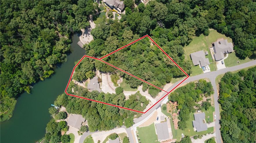 Park-Like, Secluded Lake-Front Living! 1.66 double lot with killer views and a private dock and covered boat lift. The oversized kitchen features granite counters, a double oven, gas cooktop, coffee station and massive amounts of storage. Throughout the upstairs, enjoy expansive lake views with 3 double doors accessing the deck and screened in porch. The upper living area has a propane fireplace while the lower level has a wood burning fireplace. In the primary bedroom + bath you'll find a private deck area, two walk-in closets, gorgeous marble double vanity, soaking tub, tiled shower and another walk-in closet. The laundry room has a sink with granite counters and even MORE storage. Downstairs you'll find 2 bedrooms, one full bath, and another living room/game room - the pool table conveys- and a wet bar to entertain your guests! Ice machine, sink + mini fridge in the downstairs bar convey as well. Brand new HVAC system in Jan 2024, Hot Water Tank 2019. New dishwasher in 2025. Lower level shop area + so much more!