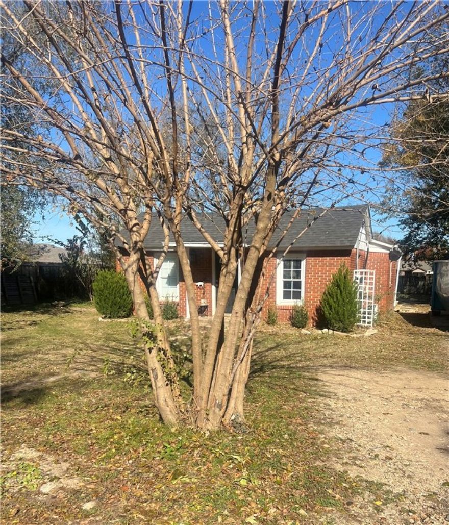 INVESTORS, this one is SO cute & Great location, right in the middle of town!  All brick home with 2 bedrooms, 1 bath, & parking pad.  Stainless stove, refrigerator, & microwave.  Updated bathroom, new roof in 2020, new hvac 2020, new tile flooring, washer/dryer will convey, new back deck overlooks huge back yard. Back on the market due to Buyer's lending, at no fault of the seller.
