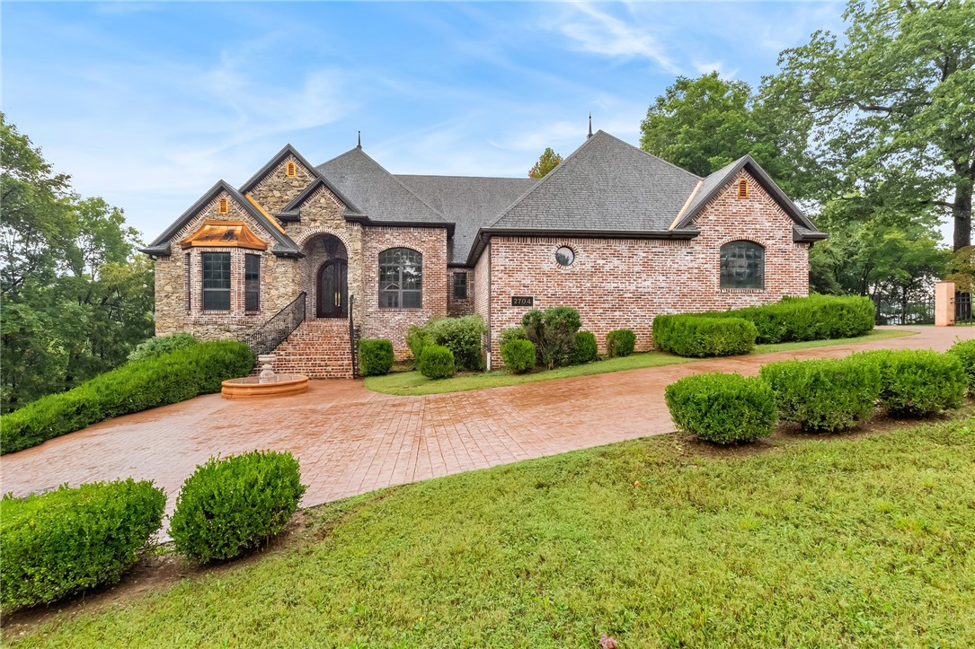 An amazing opportunity to own this gorgeous estate in one of the best Bentonville locations. This gem sits in the coveted Hidden Springs subdivision. Nestled on just over an acre of wooded bliss and situated just off the Bentonville trail system. Pulling into the large driveway you are greeted by a brick courtyard with a fountain and grand front entry. The main level has 3 bedrooms and 3.5 baths. Additionally, you will find a formal dining room, an office, and an eat-in kitchen. The lower level features an in-law apartment with a full kitchen and bath. This lower level would be a great spot for long-term guests or to rent out and generate income!