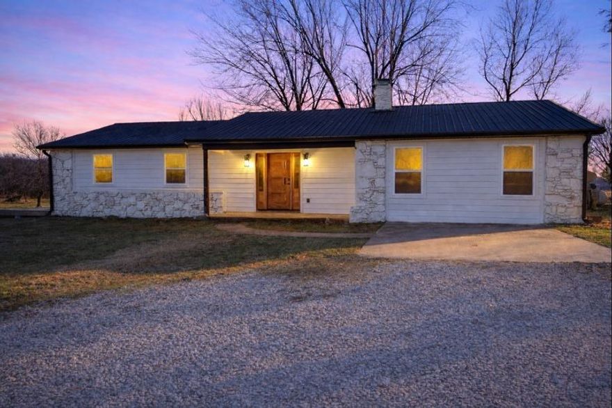 Contemporary farmhouse charm meets hobby farm! This completely updated 3-bed, 2-bath home sits on 7.5 acres, & it's 4 minutes from Wal-Mart. The interior features a gorgeous kitchen designed to impress & will have you offering to host every holiday this year! Dreamy primary suite featuring a spa-like bathroom with dual-head shower & a relaxing soaker tub. The walk-in closet feels straight out of a design magazine it's both stylish & functional. The mudroom is spacious & cleverly tucked away & fully hidden behind custom cabinetry for a clean, seamless look. The exterior features a powered pole barn with 110 amp & 220 amp bays, a dirt bike track, stunning sunsets, an apple tree, wild blackberries, & raised U-shaped garden beds. It even has a 50-amp RV site with its own septic & porch. The updates are endless: HVAC, tankless water heater with scale inhibitor, PEX plumbing, Low-E windows, new gutters with leaf-guard protection, and fireplace to name a few. It's quiet acreage living, with everyday convenience, & style!
