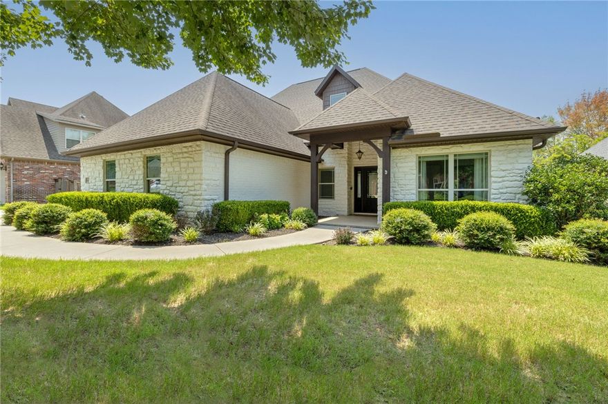 Imagine coming home to this lakefront setting in East Fayetteville every day! Less than a mile from all that the intersection of Mission & Crossover has to offer, this all brick & stone, 3,601 SF home displays 4 bedrooms, 4 full bathrooms, formal dining room, large bonus room and an office/flex space which was used as an extension of the primary walk-in closet by the current owner. This mostly one-level, split floor plan features mixed-width hickory wood flooring in living areas and the primary bedroom, and new carpet (2023) in bed and bonus rooms. A spacious kitchen includes double ovens, 5-burner gas cooktop, nugget ice maker, two sinks, and barstool seating space for 5+. The large covered back patio maximizes the lake view from the outdoor living area with wood burning fireplace, built-in gas grill, outdoor TV and built-in speaker system. Additional features include a large utility room, 3-car garage, and an extended patio with wrought iron fence that preserves the peaceful view overlooking Broccardo Lake.