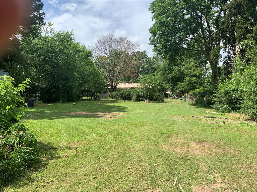 Must see this property in person to believe how gorgeous it is! There are Apple, Peach and Pear ,beautiful wisteria and hydrangeas. Several good garden spots and lots of room to have animals or room to play. It has a chain link all the way around; room for animals or play yard. Many shady spots to enjoy!
Also has Sunroom/playrm (was a daycare). Refrigerator and stove will convey to new owners.