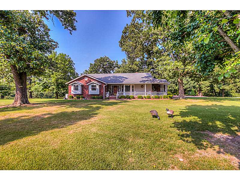 COUNTRY LIVING - Enjoy peace and quiet on the manicured level 5 acres surrounding this country home, yet convenient to downtown Bentonville. Offers 3 bedrooms, 2 bathrooms, casual living room with wood ducted fireplace, built-in bookcases, hardwood,flooring, upgraded kitchen with SS appliances included, custom cabinets. House has electric backup generator, tractor and mower is negotiable with right offer. Tucked back off Hwy 72 East you'll find this this little piece of country paradise!