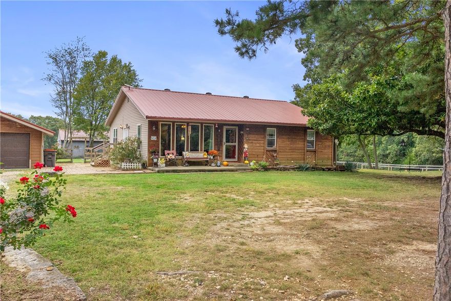 LIVE YOUR BEST LIFE on this small farm on the outskirts of Pea Ridge. This well maintained home has new energy efficient windows, detached garage, barn, a full RV Hook Up with septic and 30 & 50 amp as well as a fenced back yard area. Watch the Sunrise from the front porch or the Sunset and abundant wildlife from the back deck. Bring your chickens for farm fresh eggs as there is already a Coop. Come inside for a cup of coffee by the warmth of the pellet stove, great living room and very functional kitchen. If you need office space YOU GOT IT just off the Master Bedroom. DON'T BLINK IT WILL BE GONE. WELCOME HOME!!!