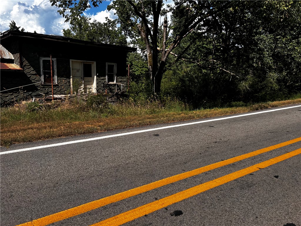 2.34 acres outside of city limits, approximately 6 miles north of Clarksville. There is an old structure on site. Electric and water is available at road.
