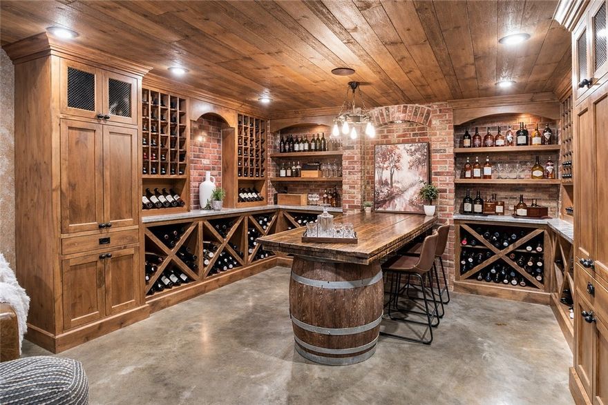 Walkable downtown Bentonville living just minutes from the Square, Crystal Bridges, and the Razorback Greenway. This Craftsman-style home delivers rare amenities—including a private hot tub terrace and wine cellar/speakeasy—paired with true lock-and-leave convenience in one of the city’s most sought-after locations.

Offering 4,148 sq ft across three levels, the main floor features wood beams, custom built-ins, hardwood floors, and a chef’s kitchen with granite counters, dual ovens, farmhouse sink, and walk-in pantry. The finished lower level includes a custom wine cellar and tasting room, plus dedicated fitness space. The main-level primary suite offers a spa bath and private terrace with built-in hot tub. A curated outdoor entertaining courtyard provides privacy without the maintenance of a large yard. A rare opportunity to secure scale and curated amenities within one of Bentonville’s most desirable downtown corridors.