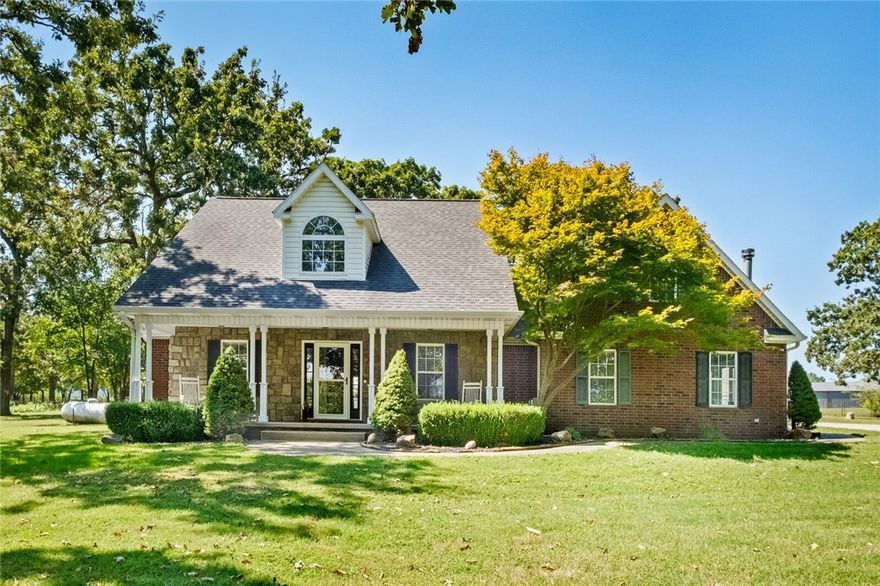Don't miss this diamond in the heart of NWA! Fully updated, this home brings modern style to serene country living. The home features 4 bedrooms, dedicated office, 2 family rooms, upgraded flooring, granite counters, fresh paint and so much more. The open kitchen features full-height cabinets, island with oversized bar seating and bay-window dining. One family room boasts a pellet stove, 15+ ft ceilings and an updated overmantel. The other family room has an abundance of natural light and wood burning stove for cozy evenings. The primary bedroom suite includes a remodeled bath with soaker tub and walk-in shower. Set on large in-town acreage, the property has fully upgraded horse fencing, a large 2 mate stall barn with tack room, loafing shed, chicken coop, and operational well for livestock/irrigation. Enjoy the oversized front porch, back patio, mature trees, and wide-open pastureland, while still being near all things NWA. The perfect blend of farm life and suburban convenience awaits! Feature sheet available.