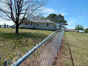 This is a nice home on the east side of Berryville just one block from the hospital. Carter is the street going to the hospital. The home is 3 bdrm and 2 bath with 2 storage buildings in a chain link fence all the way around the home. One building was a work shop and is 600 sq. ft. has electric and 2 rooms. Vinyl siding and a porch on the front and a patio porch on the back.