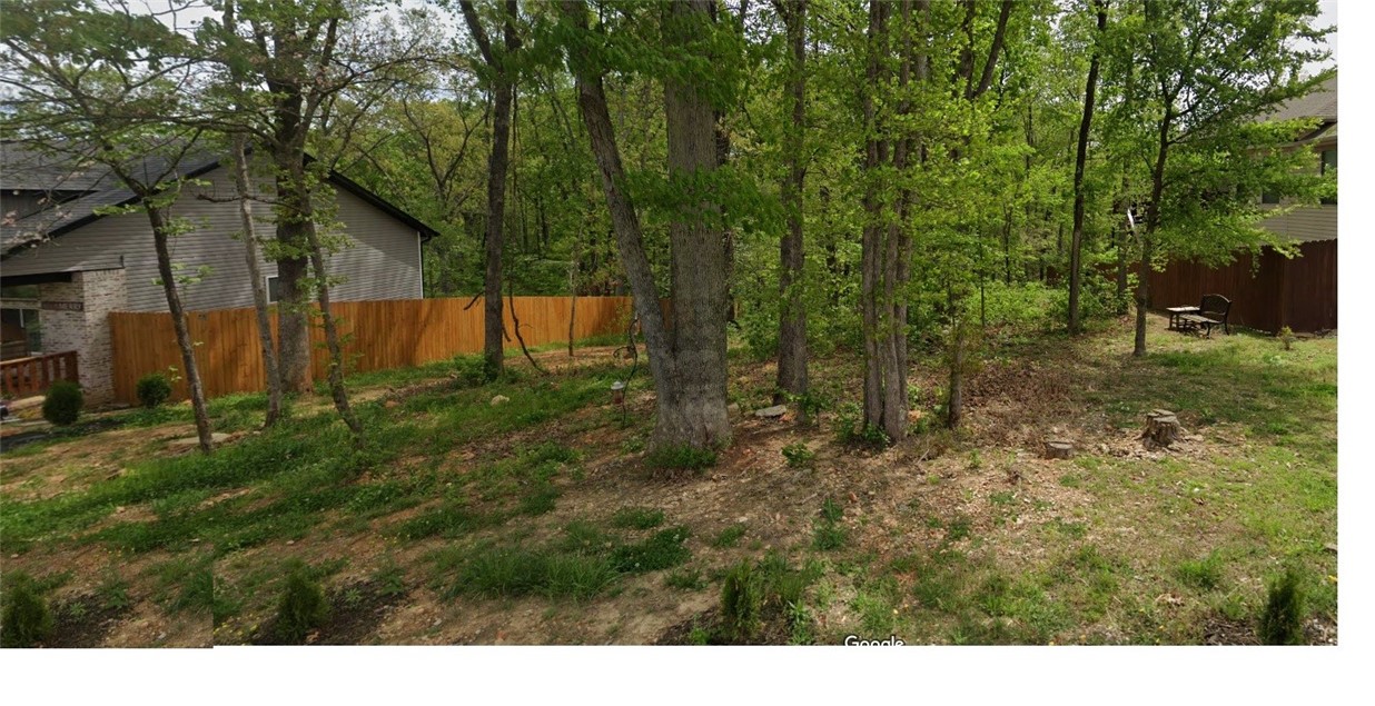 Rare! sewer lot Situated at the "dead end" of the first short leg of Westmorland, it is an idyllic private "peninsula" with an abundance of wooded common area, homes on the street are higher end which means your new home will have great comps.Great location. Close to the Country Club Golf Course, Town Center/Harps, and Bella Vista Way.