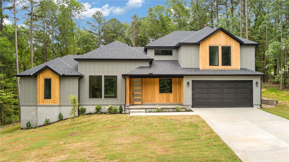 Discover modern luxury in this stunning new construction home in Bella Vista, perfectly situated on a private lot with a large, flat backyard surrounded by mature trees for unmatched tranquility. This thoughtfully designed home features custom finishes that set it apartāenjoy a show-stopping waterfall quartz kitchen island, soaring windows throughout, and striking cedar accents on the exterior. Inside, youāll find gorgeous hardwood floors, designer lighting, and a custom fireplace surround with a wood-accented hearth. The primary suite on the main level offers a spa-like ensuite bath. Buyers will appreciate the spacious mudroom, oversized laundry room, and flexible upstairs officeāideal for working from home. This home combines functionality, privacy, and high-end style in one of Bella Vistaās most desirable settings. Donāt miss the chance to make it yours!