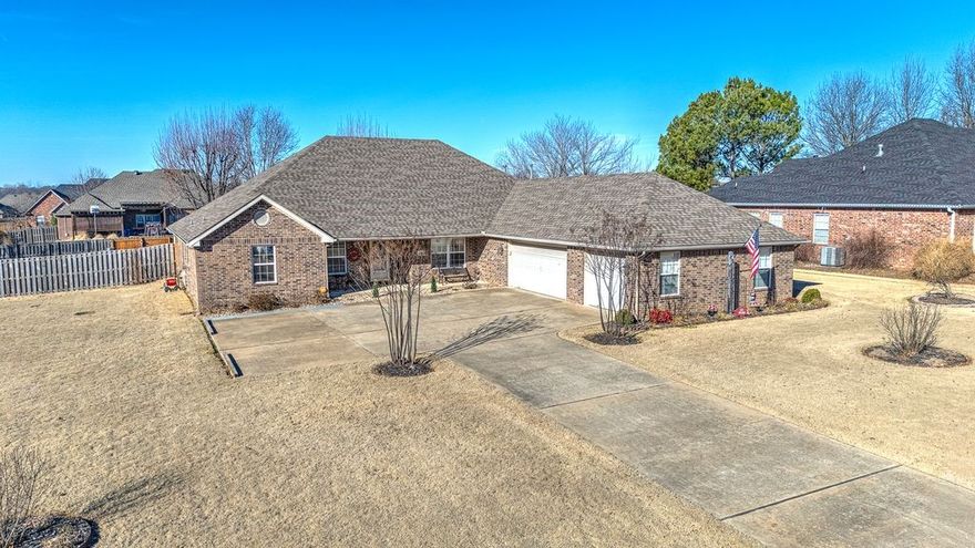 Imagine coming home to a quiet, tree-lined street in Wellington Heights, where this beautifully maintained 2,798 sq ft home sits on a spacious 0.60-acre lot in Cave Springs—voted the safest city in Arkansas in 2025. Step inside to warm oak trim and doors, built-in shelving, and a stunning custom rock fireplace that anchors the open living and dining space. The kitchen invites gatherings with a gas cooktop, double convection ovens, under-cabinet lighting and corner pantry. A split floor plan offers oversized bedrooms with walk-in closets, while guest rooms share a Jack-and-Jill bath with double vanities. A dedicated office makes working from home easy. At day’s end, retreat to the primary suite with new carpet and a spa-like bath featuring heated tile floors, dual vessel sinks, and an oversized shower. Enjoy mornings on the covered back patio, extra storage in the floored attic above the 3-car insulated garage, and community perks like a clubhouse, pool, and playground—all in the Bentonville School District.