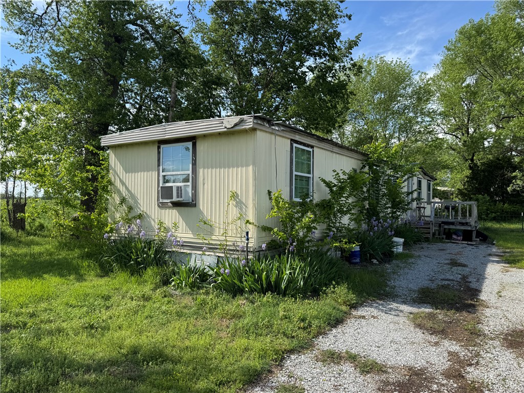 One acre of level land outside of the city limits awaits for you to make it your mini homestead or build your future home! It has a 14ft x 60ft, 3 bedroom, 1 bath Mobile Home onsite. Some inside updates have been made and it's ready for the finishing touches. Window units in all the main rooms. This could be your investment rental or your home. Call to schedule your showing today! (more pictures coming soon).