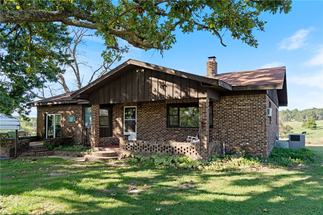 Lovely and low maintenance ranch style brick home sitting on a pristine +/- 10 acre lot with access to purchase an additional 3 acres if desired. This somewhat rural property sits just outside the city limits but is still less than 8 minutes from town. This 3 bedroom 2 bath family farmhouse has great bones and lots of room both inside and out. The home is super cozy and although it could use some cosmetic upgrades it is built to last and should be easy to overhaul. Solid wood floors are in amazing shape and the bedrooms are comfortably oversized. The original design called for a garage but that was turned into the 3rd bedroom with ensuite bathroom. The large sunroom in the back is the perfect spot to relax and unwind with a soak in the hot tub which will convey with the property. This property is ideal for a small hobby or horse farm. The pasture is perfect for cattle and there is even a pole barn for hay and tractor/boat storage. There is a shared well as this property was a family farm that has been divided.