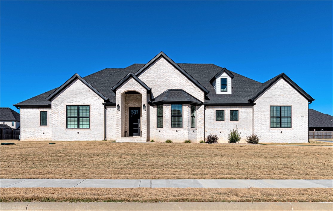 Stunning custom built home in very desired Elmdale Lake Estates Subdivision with 30K worth of upgrades, situated on half an acre lot. Great location, easy to get to everything within NWA, 15 min away from Tyson HQ. This luxury home contains 17' cathedral ceilings with flying handcrafted wooden beams and brick gas fireplace with shiplap to the ceiling in the living room. Foyer with beams and accent wall. Double glass door in office with built-in wine rack. Kitchen features 9ft island with bar top, pot filler, and shiplap wall in dinning area. The master suite is a dream with barn door, shiplap wall, large walk-in tiled shower with 2 shower heads. You will love the gigantic master closet with built-in central island and bench. Two other bedrooms downstairs with Jack and Jill, and huge walk in closet. Upstairs in-law suite with bonus room. Floored attic Storage, 24 ft deep garage w/ insulated doors. Large covered patio with brick gas grill and spacious backyard ready for your future pool. Zoned for Harber High School.