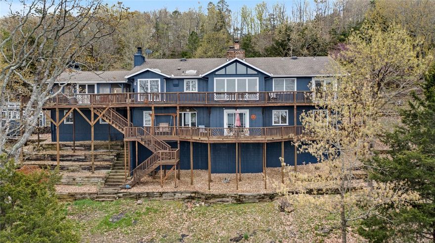 Breathtaking panoramic views from every room of Beaver Lake. This home sits on nearly 2 acres, in a peaceful setting with trees, and lots of wildlife. This home comes with a Private Beach, private boat dock. The shoreline is easily walked or can be reached by UTV. There is a detached 32x21 shop/one car garage, and 12x20 insulated, heat and air, SheShed and full house generator. The home has been recently remodeled, with all new paint, granite counters in bathroom, Quartz countertops in the kitchen,  premium  Hickory wood floor and  carpet on the lower level installed 1 yr ago.Large Chef's kitchen with built in fridge and double oven Thermador stove. 25x25 screened porch with built in kitchen. Two decks. 2nd Living/game room/bar, 2 bedrooms and an office/5th bedroom on lower level.  Sit on the deck and enjoy watching your kids and grandkids as they fish from the shore or the dock.  No pets, non smoker. AGENT OWNED.