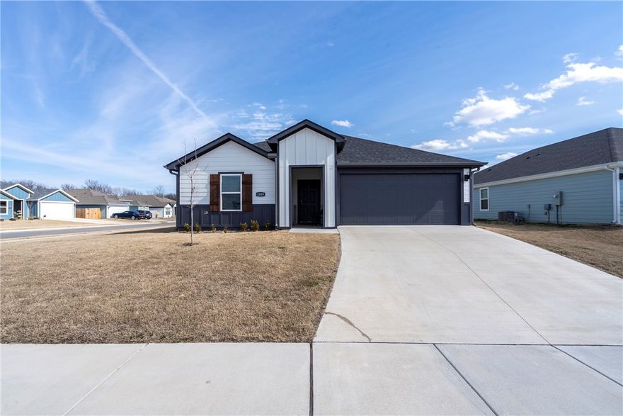 Completed in July 2024, this 4 Bed 2 Bath home offers a spacious open floor plan designed for both everyday living and entertaining. The oversized bedrooms provide generous space and flexibility, while the light-filled living area flows seamlessly into the kitchen and dining spaces. The kitchen features granite countertops, stainless steel appliances, 36” cabinets with crown molding, an undermount sink, pantry, and LED lighting throughout. Luxury vinyl plank flooring runs through the main living areas, adding both style and durability. Recent upgrades include a new roof & gutters installed August 2025, new screened in patio, blinds, and privacy-fenced backyard — perfect for pets, play, or relaxing outdoors. Refrigerator, washer, and dryer all convey, making this home truly move-in ready. The exterior offers four sided Hardie siding, covered front porch & patio & a desirable corner lot in a subdivision with cul-de-sac streets. Conveniently located to schools, parks & downtown Siloam Springs. This is a must see!!