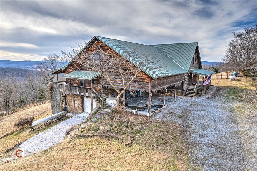 One of a kind cedar & stone home with incredible view. The main house is very open with wood vaulted ceiling and windows floor to ceiling. The guest house is connected by a breezeway and it has kitchen, eating area, 2 bedrooms and 1 1/2 baths. One car garage/workshop is heated & cooled 775 sq ft but not included in the square footage. The guest house has rented for $1,200 monthly and $169 on AIRBNB. Updates include: enclosing breakfast area into bedroom, cabinets in living area, roof, downstairs bathroom and utility room, total kitchen with new appliances and quartz countertops, tankless hot water heater, new supports under house & top windows sealed. With acceptable offer, refrigerators in main house and guest house will convey. Washer/Dryer in guest house will convey. You will feel like you're on vaction with wrap around deck and view.