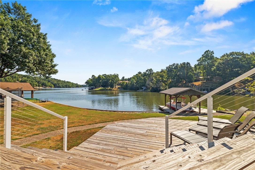 Unbeatable lakefront home with expansive lake view and level backyard only ten minutes to town. Complete with a private boat dock, swim platform, and a grass lawn on Lake Windsor. Fantastic lake views throughout the home. This home feels private yet is in a walkable neighborhood near Tunnel Vision bike trail. The living room's stone fireplace, built-in bookshelves and the wood floors deliver a relaxing lake life experience. The lakeside deck is perfect for al fresco dining. The beautiful kitchen connects to a a second patio area for morning coffee. Master bedroom and bathroom are on the main level. Two bedrooms and a full bath are upstairs. One bedroom, bathroom, and second living space in the finished walkout basement with second wood burning fireplace. Flat front lawn, mature trees and a three car garage with workbench and extra storage.