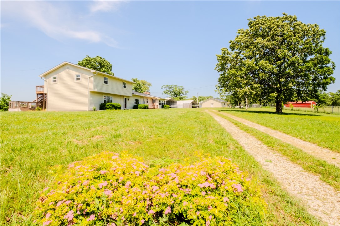Gorgeous Gorgeous Gorgeous 63 acres! 2 homes!!! Looking for a hobby farm? This home features 37 ac pasture & 26 ac woodlands with trails for your ATV. An additional 1500 SF, 3-bedroom, 1 bath GUEST HOUSE is included, which brings the living space up to 4364 SF! (averaging $245/sf). Enjoy the views and wildlife from the back decks. The entire property is fenced & gated. Two stocked ponds, a workshop, a new barn, a 2-horse cedar stall, a working corral, and 4 outbuildings to hold farm tools. All tools, Zebu cattle, chickens, and shop equipment are negotiable with an accepted offer.