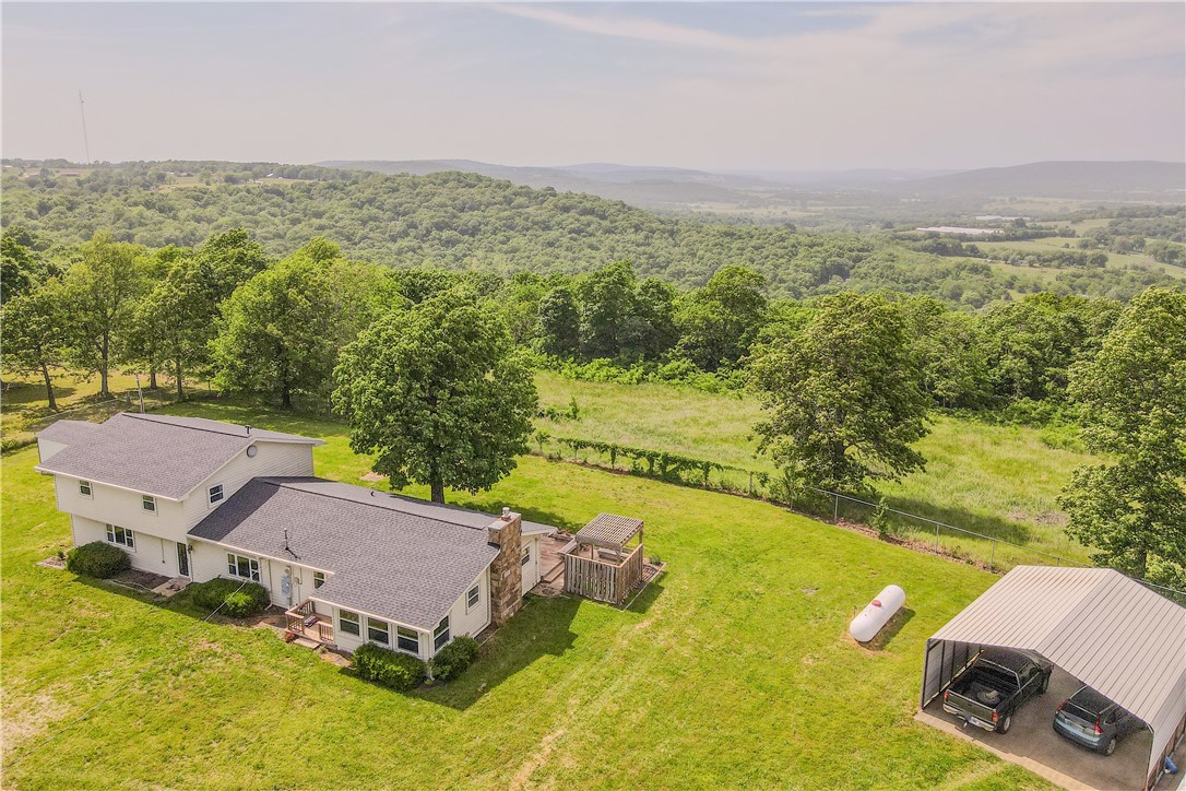 63 acres! 2 homes!!! Looking for a hobby farm? This home features 37 ac pasture & 26 ac woodlands with trails for your ATV. An additional 1500 SF, 3-bedroom, 1 bath GUEST HOUSE is included, which brings the living space up to 4364 SF! (averaging $245/sf). Enjoy the views and wildlife from the back decks. The entire property is fenced & gated. Two stocked ponds, a workshop, a new barn, a 2-horse cedar stall, a working corral, and 4 outbuildings to hold farm tools. All tools, Zebu cattle, chickens, and shop equipment are negotiable with an accepted offer.