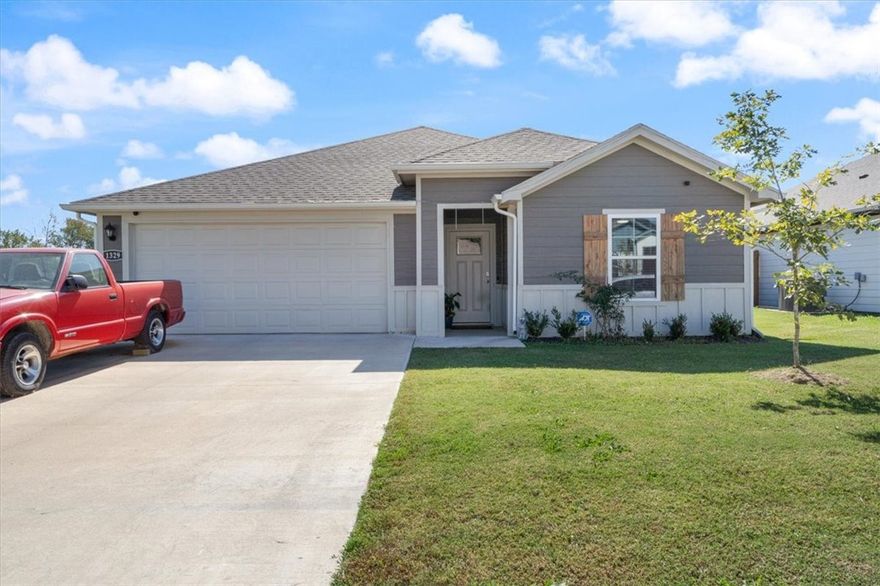 Like new- Built in 2023, this home offers over 2,000 sq. ft. of thoughtfully designed living space- making it one of the larger homes in the neighborhood. With 4 bedrooms, 3 full baths, and a flex/office room, this floor plan provides exceptional comfort and versatility. The open-concept design features a bright kitchen with quartz countertops, stainless steel appliances, a large island, and a walk-in pantry, perfect for entertaining or everyday living. Enjoy durable Luxury Vinyl Plank flooring throughout, energy-efficient details, and LP Smart Siding for low-maintenance appeal. Outside, a covered patio overlooks the privacy-fenced yard on a corner lot, complete with landscaping and a two-car garage. Located in Main  Street Village, this home is close to Gentry schools, parks, shops, and dining, with easy access to Highway 12 and 59 for quick commutes to Siloam Springs and Bentonville.