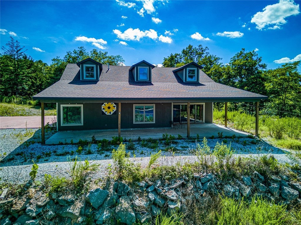 Custom built in 2019 this 3 BR 2 BA home on Beaver Lake features a BIG LAKE VIEW, is completely secluded on 27 +/- ACRES and has a private BOAT DOCK with one 24' slip! The home has plenty of space to spread out indoors and out with over 2,330 sqft of living space and the 27 acres of land!! The home is all on one level has an open concept living, dining and kitchen. Kitchen features custom cabinets, granite tops and splash and stainless appliances. Wood burning stove for back up heat. There are a few additional potential home build sites or you can enjoy the privacy of the acreage to yourself. The roads are paved all the way to the driveway.