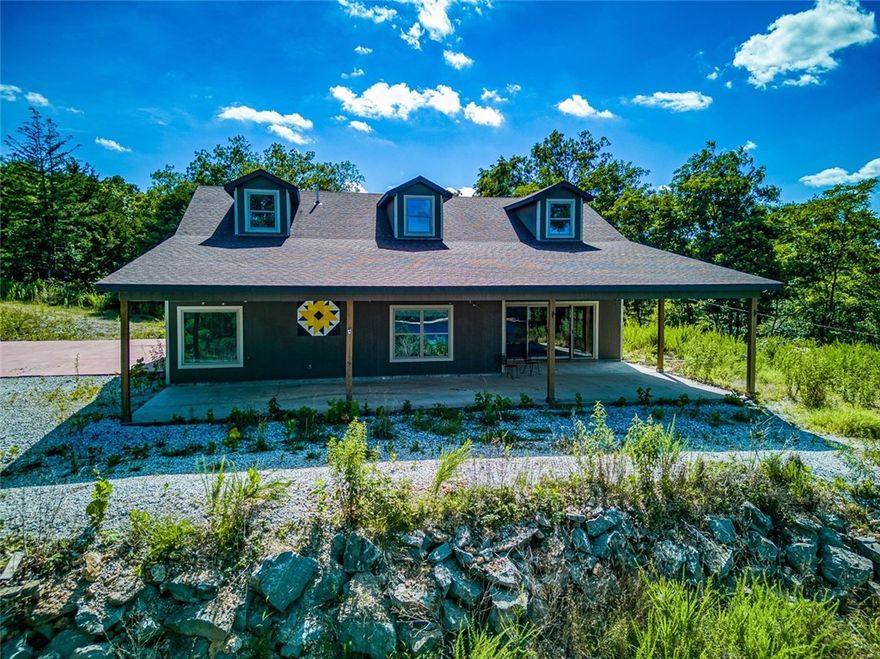 Custom built in 2019 this 3 BR 2 BA home on Beaver Lake features a BIG LAKE VIEW, is completely secluded on 27 +/- ACRES and has a private BOAT DOCK with one 24' slip!  The home has plenty of space to spread out indoors and out with over 2,330 sqft of living space and the 27 acres of land!!  The home is all on one level has an open concept living, dining and kitchen.  Kitchen features custom cabinets, granite tops and splash and stainless appliances.  Wood burning stove for back up heat.  There are a few additional potential home build sites or you can enjoy the privacy of the acreage to yourself. The roads are paved all the way to the driveway.