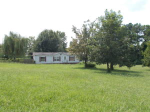 Double wide with brick underpinning. Living room PLUS den with fireplace. 3 bedrooms and 2 full baths. Asphalt shingle Roof needs repair. Other repairs needed but priced accordingly. Buyer to inspect as desired but sold as is where is.