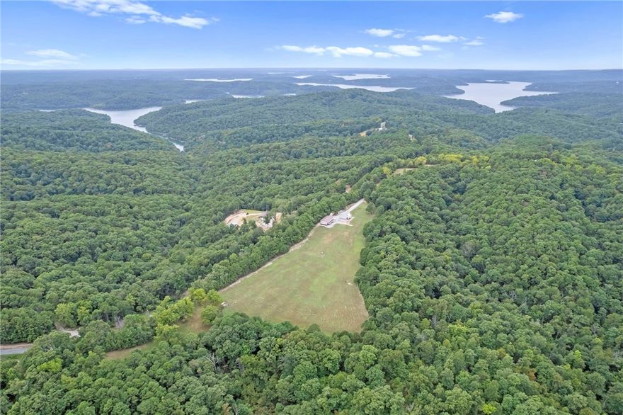 Gorgeous barndominium on a park-like setting minutes to the Clifty Boat Ramp in Eureka Springs, AR! Tucked off the road at 601 County Road 152, this well-kept retreat offers flexible purchase options of 8±, 22±, or 38± acres—bring your dreams, animals, and toys. The 2-bed, 2-bath layout features two living areas for easy entertaining or a home office/media space. An oversized garage provides exceptional storage/workshop potential for boats, UTVs, and equipment. Outdoors you’ll find manicured grounds that truly feel like a private park, plus a travel-trailer/RV hookup for guests or adventure-ready weekends. Enjoy quiet country living with quick access to Beaver Lake recreation fishing, boating, and swimming just about 5 minutes away—while still close to the dining, arts, and charm of historic Eureka Springs. A rare NWA find that blends low-maintenance living with room to grow, buy the home on 39± acres for your private estate or hobby farm.