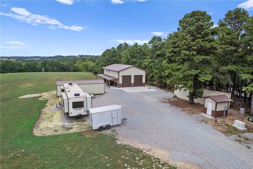 Gorgeous barndominium on a park-like setting minutes to the Clifty Boat Ramp in Eureka Springs, AR! Tucked off the road at 601 County Road 152, this well-kept retreat offers flexible purchase options of 8±, 22±, or 38± acres—bring your dreams, animals, and toys. The 2-bed, 2-bath layout features two living areas for easy entertaining or a home office/media space. An oversized garage provides exceptional storage/workshop potential for boats, UTVs, and equipment. Outdoors you’ll find manicured grounds that truly feel like a private park, plus a travel-trailer/RV hookup for guests or adventure-ready weekends. Enjoy quiet country living with quick access to Beaver Lake recreation fishing, boating, and swimming just about 5 minutes away—while still close to the dining, arts, and charm of historic Eureka Springs. A rare NWA find that blends low-maintenance living with room to grow, buy the home on 39± acres for your private estate or hobby farm.