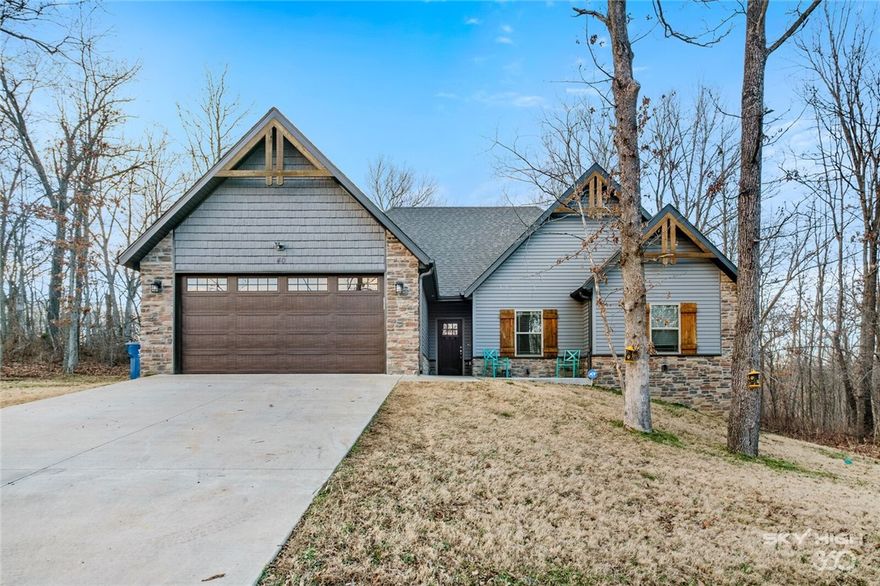 2019 Built Craftsman Style Home in the Bentonville School District.  Good size flat yard with Covered back deck and wooded views.   Split floor plan with 3 Bedrooms, 2 baths and and Home Office on the main floor. A large bonus room upstairs completes the floor plan. Modern Rustic style home with stonework and cedar accents inside and out.  Nice size pantry, Propane Gas fireplace, Granite Countertops with under-mount sinks, 2 Car Garage.  Master Suite has separate shower, jetted tuba and large walk-in closet.