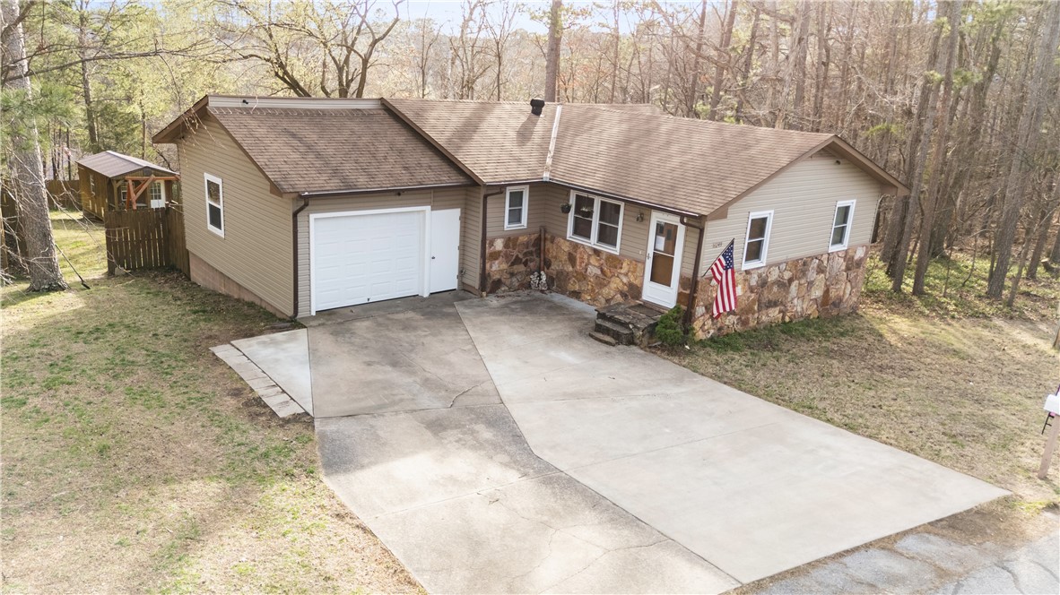 Come check out this amazing 5 bedroom home that is located in the pine trees near Beaver Lake! The walk out basement has been fully remodeled; including new paint, vinyl flooring, updated bathroom and light fixtures that provides lots of flexible space including office option, craft room option, and two sheds/workshops. Carpet in the living room was replaced in 2023 and new marble kitchen countertops! Enjoy the beautiful woods while relaxing on your back deck. There is boat launch access at the end of the street!