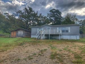 A lot to love with a little price! This home on almost an acre features a large open large living room/kitchen area, 2 bedrooms 2 full bathrooms. Handicap ramp on back deck for easy access, and a Cedar Workshop.