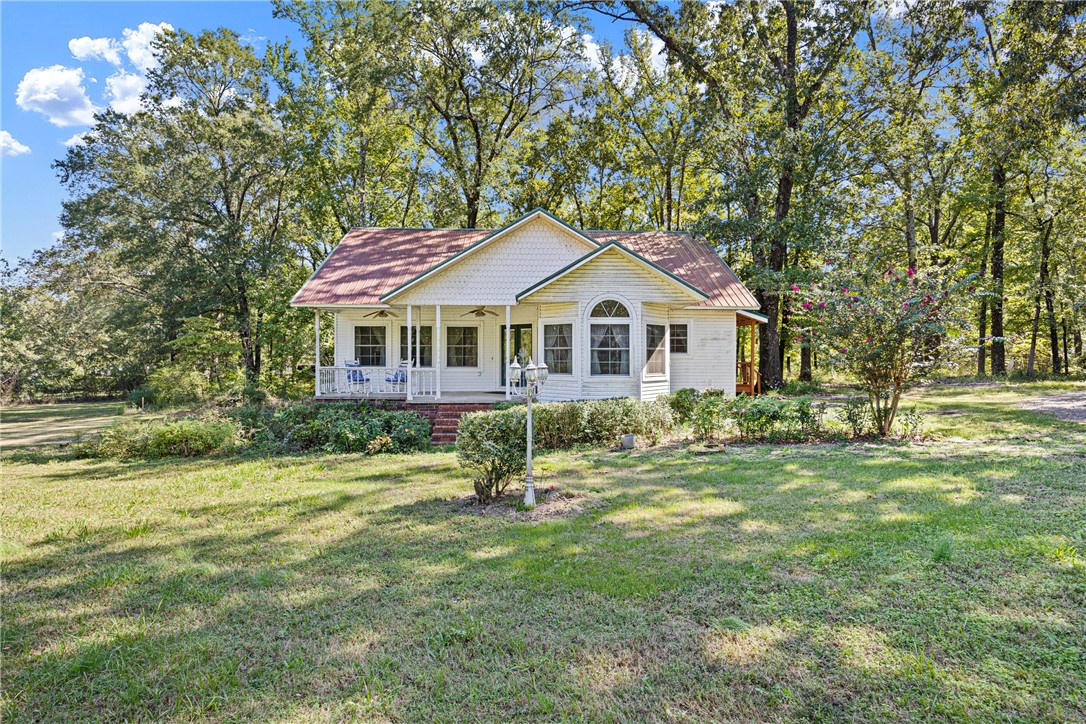 Tucked just moments from Lake Nimrod, this darling Plainview cottage overflows with warmth, whimsy, and personality! Resting on .81 acres surrounded by trees, itās the perfect blend of privacy and proximity to all the outdoor funāboating, fishing, hiking, and peaceful evenings under the stars. Step inside and youāll instantly feel at home with cozy touches, tall ceilings, and character in every corner. The inviting layout flows easily from room to room, offering charming details you wonāt find in cookie-cutter homes. A comfortable primary suite, welcoming living area, and bright kitchen make this home as functional as it is unique. Outside, thereās plenty of space to garden, relax, or simply breathe in the quiet. Whether youāre looking for a weekend retreat or a full-time escape, this sweet spot near Lake Nimrod is that rare find that feels equal parts storybook and sanctuary.