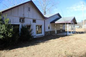 Approximately 2400 sq ft house with added 2008' building connected to house. The house has 3 bedrooms and 2 baths with a large living area and kitchen and dining area. The property is near an access point to Lake Nimrod. This would be a great get-away or home. There is an attached 2000 sq ft m/l storage building BUYER TO VERIFY SQUARE FOOTAGE OF BUILDINGS. Info per Yell County Tax Records.