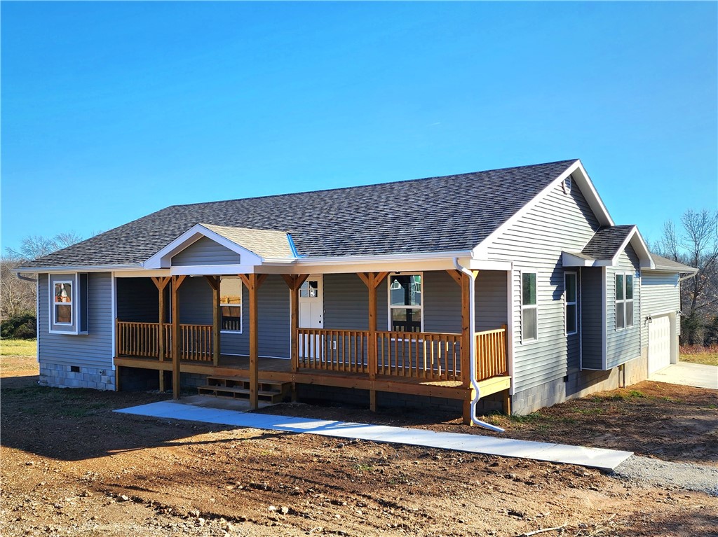 NEW CONSTRUCTION located in Bar L Estates, sitting on a half-acre lot! When you aren't relaxing on your full-length front porch, you will be welcoming and entertaining all your friends and family in the abundant space of this open concept design. The spacious living room, designated dining area, and beautiful kitchen are all bright and inviting with ample natural light coming in from all sides. The back porch, conveniently located through the kitchen door, is a perfect location for grilling. Just off the dining area, behind two large barn doors, is a flex space that could be used as a butler's pantry, home office, children's playroom, or possible 4th bedroom. As you walk through the beautiful arched hallway, you will find 3 bedrooms and 2 baths. Double sinks and a tiled walk-in shower, along with a large walk-in closet, are located in the Primary Bed and Bath. Vinyl plank wood floors throughout main living areas and bedrooms. A 2-car garage is located in the rear of the home with entry through the laundry room.