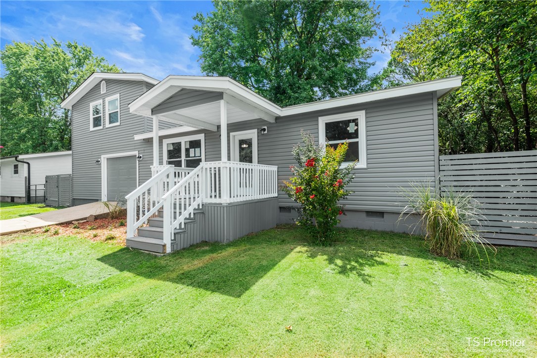 Holy HOUSE! What a great opportunity for room to grow...or just separate! We are all spending more time at home these days and this house gives everyone the opportunity to spread out. This home went through a full remodel down to the studs, all work permitted through the City of Fayetteville. The Master suite, a second bedroom, full bath, living room, laundry, and bonus room are down stairs. Three bedrooms and a full bath are upstairs. The fully fenced backyard is accessed through the bonus room, has a deck and large shade tree. The garage was also freshened up and has a large area for a tinkering or extra storage! Flagstone walk way in the process of being installed from drive way to front porch.