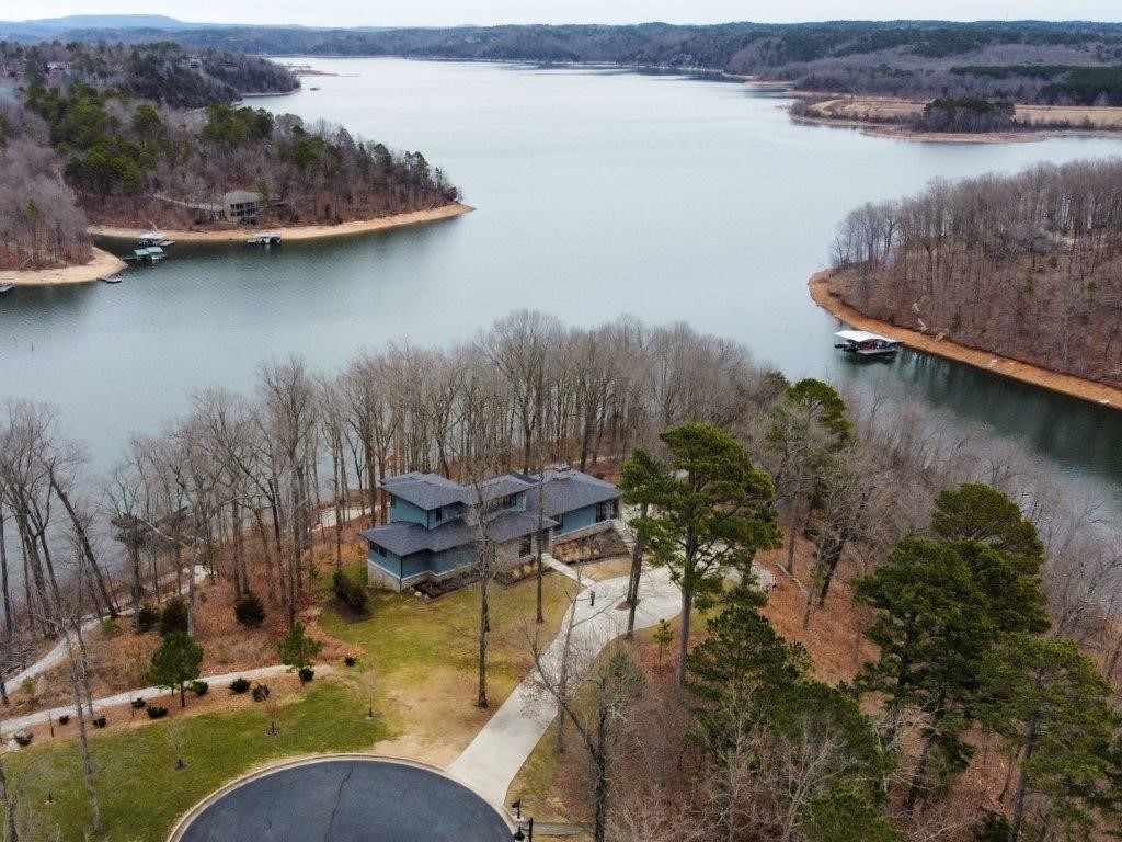 Own your own peninsula on Beaver Lake with a private four slip dock. This stunning lake front home is located minutes from downtown Rogers and sits on 2.6 acres with 617' of shoreline. The 5.5 year old contemporary house has 4 bedrooms, 5.5 baths and loaded with custom high end amenities. Great lake views from the large covered outdoor patio featuring a wood burning fireplace. Other amenities include a chef's kitchen and his/her master baths and closets. One of a kind lake paradise in Northwest Arkansas.
