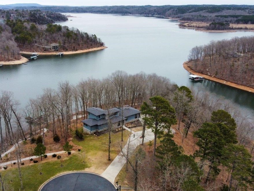 Own your own peninsula on Beaver Lake with a private four slip dock.  This stunning lake front home is located minutes from downtown Rogers and sits on 2.6 acres with 617' of shoreline. The 5.5 year old contemporary house has 4 bedrooms, 5.5 baths and loaded with custom high end amenities. Great lake views from the large covered outdoor patio featuring a wood burning fireplace. Other amenities include a chef's kitchen and his/her master baths and closets. One of a kind lake paradise in Northwest Arkansas.
