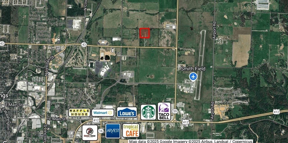 9.92 acre tract of land for sale in Siloam Springs with potential for many uses. Property is located just off Hwy 59 and within miles of a rapidly developing retail corridor along Hwy 412. Flat, cleared acreage with a small home, shop building, and a pond on site. Ideal for single-family residential, agricultural, and industrial uses. Property accessed via driveway easement. Well and septic on site, water at street.