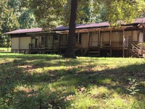 SELLING AS LAND VALUE ONLY....2 acres with city water, electric & septic already in place, 2 outbuildings, single wide mobile home on the property with no value. Mobile home can be purchased, to be moved, for $1,000.