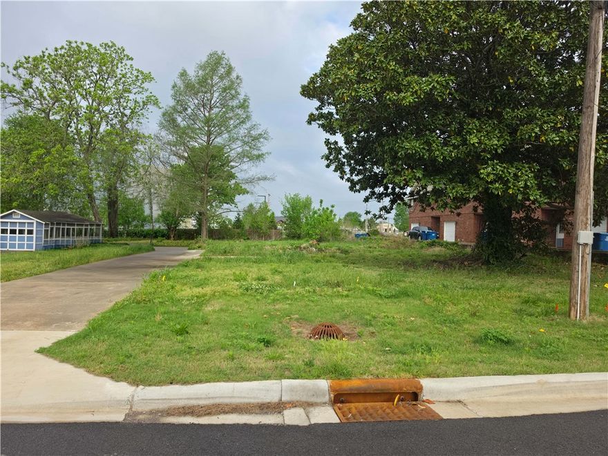 Developer's dream in the heart of Downtown Bentonville. 504 SW E Street is RC-2 zoned and ready for development — perfectly positioned between the historic Bentonville Square and the former Walmart Home Office campus, now the epicenter of NWA's most significant urban transformation.

Blue Crane (Walton family) just announced "The Hart on Main" — a landmark mixed-use residential, retail, and parking development one block from the square, breaking ground in 2026. The former Walmart campus is being redeveloped into a mixed-use district anchored by a Walton-backed STEM University opening in 2028, plus hotel, multifamily, and retail. The Compton Hotel (142 rooms) opens nearby this year. The Quilt of Parks pedestrian corridor is under construction through A Street.

The Razorback Greenway Trail at Gilmore Park is less than 100 feet away. World-class restaurants, shops, and pubs thrive within steps.
RC-2 zoning. Prime location. Generational timing. Call today.