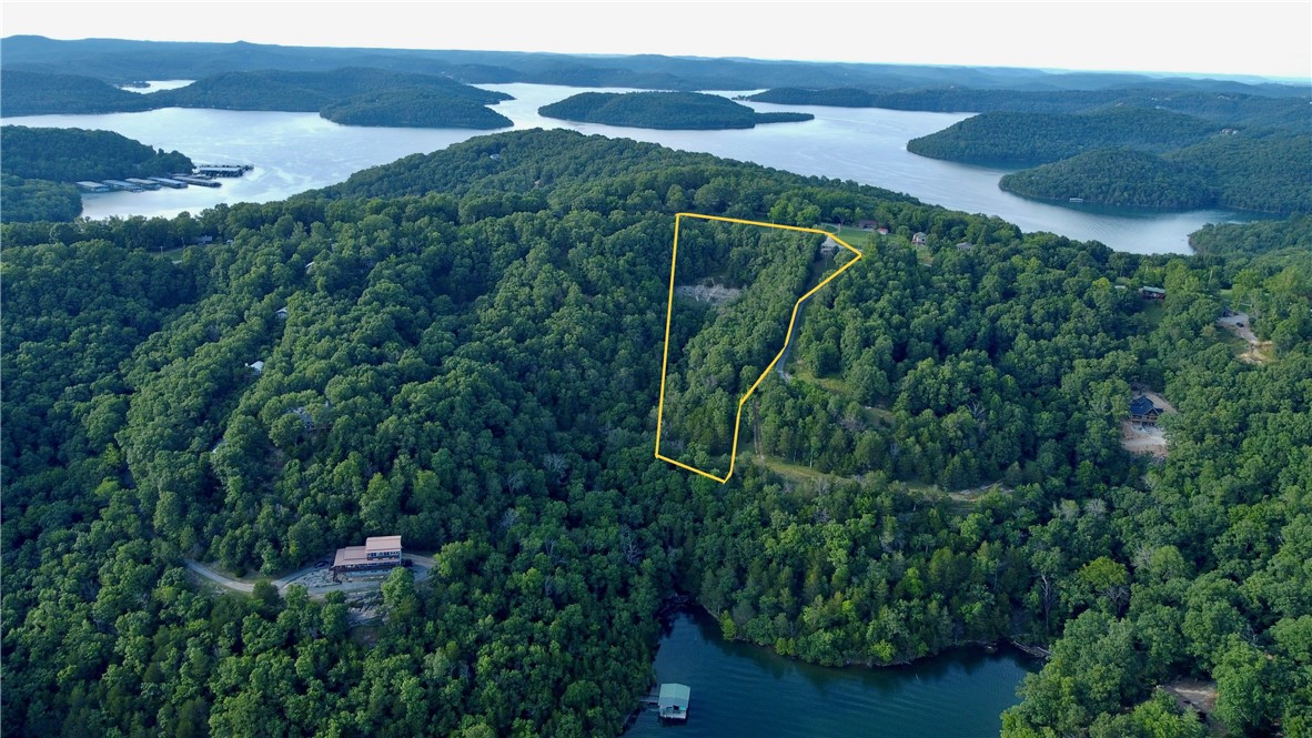 Nestled in a sought-after location on Mundell Road, this exceptional property offers a unique opportunity to build your dream home with breathtaking Beaver Lake views. Situated just one mile from Starkey Marina, you'll enjoy convenient access to all activities the lake has to offer. This cleared building location features valuable blacktop frontage on two sides, providing easy access and enhancing the property's appeal. Previously perc'd for a 3-bedroom home, this site is ready for your vision. Located just 20 minutes from Eureka Springs and 40 minutes from Rogers, you'll enjoy the perfect blend of peaceful rural living and convenient access to city amenities. The covenant-protected community ensures lasting value and a cohesive neighborhood environment. Nature enthusiasts will appreciate the abundance of wildlife, gorgeous timber, and a stunning rock bluff that adds character and charm to the landscape. This property offers a rare opportunity to create a custom home in a truly special setting.