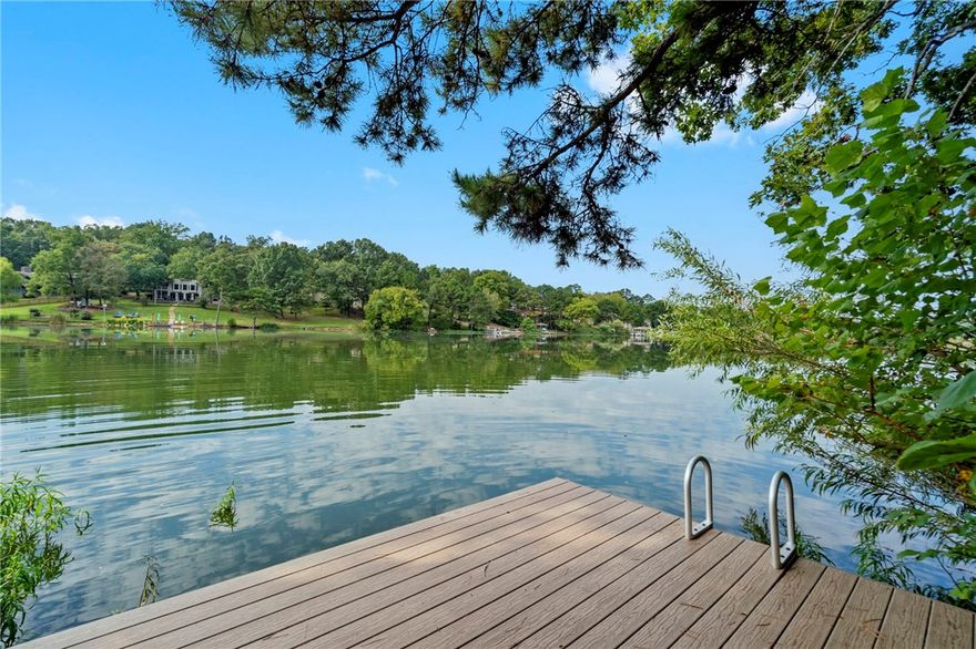 Step back in time with this rare lakefront retreat featuring its own private swim/boat dock! This 2-bed, 3-bath home embraces vintage charm with wood paneling, stone fireplace, and cozy cabin vibes throughout. Two spacious living areas and large decks overlooking the water create the perfect setting for gatherings or quiet escapes. Surrounded by mature trees and peaceful views, this property blends nostalgia with opportunity, whether you envision it as a full-time residence, vacation getaway, or investment. A true Bella Vista classic where comfort meets lakeside adventure.