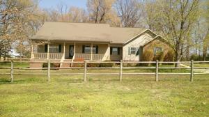 Country living only minutes from town. This well maintained 3 BR, 2BA home sets on small acreage in a great location with restaurants and a grocery nearby. Pretty view of the mountains from the front porch and a park like setting with paved driveway and plenty of concrete and paved parking.